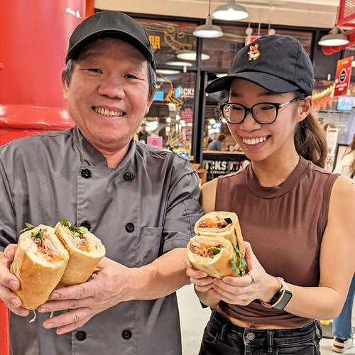 Jennifer Nguyen and her father holding banh mi at Pearl River Mart Foods