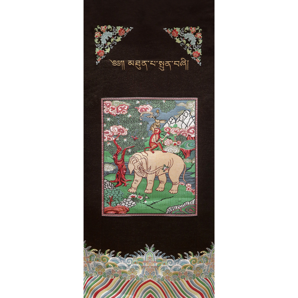 Brocade print monkey on elephant in forest.